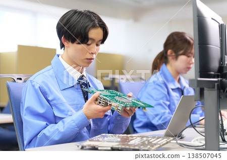 Engineers who inspect prototype circuit boards during design reviews 138507045