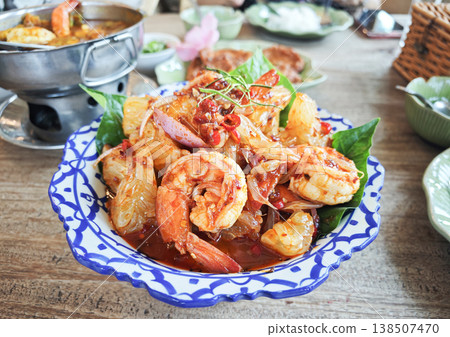 Thai pomelo salad with juicy shrimp, bold spicy and tangy flavors, fresh and colorful presentation. 138507470