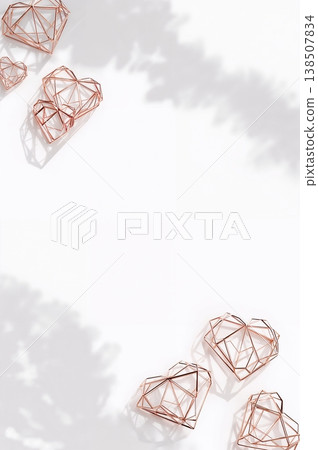 Row of gold heart shaped jewelry pieces are displayed on a white background 138507834