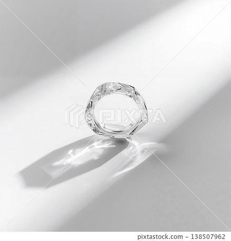 Ring with a stone in it is sitting on a table 138507962