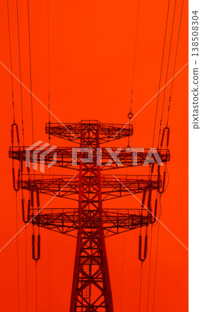 The upper part of the powerful metal column of the super powerful energy line. Powerline tower with cables isolated on a red backdrop. Problems in energy industry The upper part of the powerful metal column of the super powerful energy line. Powerline tower with cables isolated on a red backdrop. Problems in energy industry 138508304