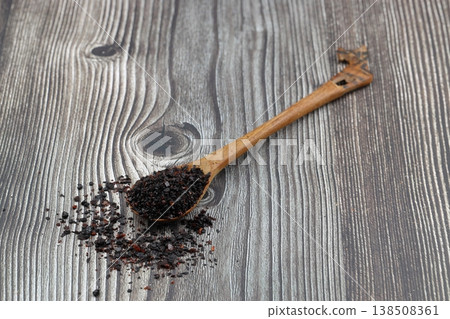Dried Isot Pepper Flakes in a Wooden Spoon on Dark Wood Background - Traditional Turkish Urfa Chili Dried Isot Pepper Flakes in a Wooden Spoon on Dark Wood Background - Traditional Turkish Urfa Chili 138508361