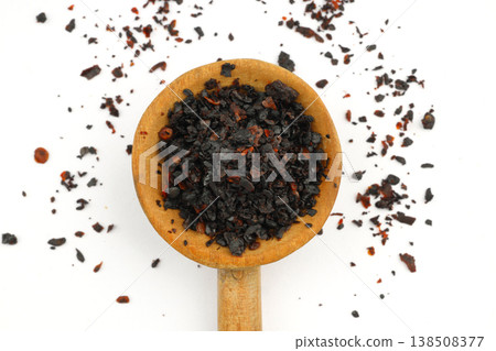 Macro Shot of Dried Isot Pepper Flakes in a Wooden Spoon Isolated on White Background - Turkish Chili Macro Shot of Dried Isot Pepper Flakes in a Wooden Spoon Isolated on White Background - Turkish Chili 138508377
