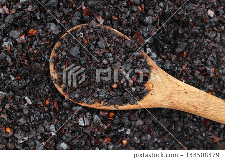 Macro Shot of Dried Isot Pepper Flakes in a Wooden Spoon Isolated on White Background - Turkish Chili Macro Shot of Dried Isot Pepper Flakes in a Wooden Spoon Isolated on White Background - Turkish Chili 138508379