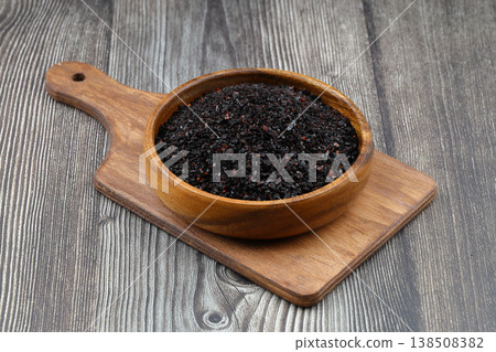 Dried Isot Pepper Flakes in a Wooden Bowl on Dark Wood Background - Traditional Turkish Urfa Chili Dried Isot Pepper Flakes in a Wooden Bowl on Dark Wood Background - Traditional Turkish Urfa Chili 138508382