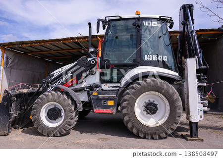 Modern agricultural vehicle ready for work near industrial building Modern agricultural vehicle ready for work near industrial building 138508497