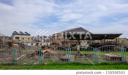Decaying rural property with collapsed roof and overgrown yard Decaying rural property with collapsed roof and overgrown yard 138508503
