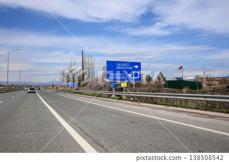 Highway scene with Hebrew road sign under clouded sky 138508542