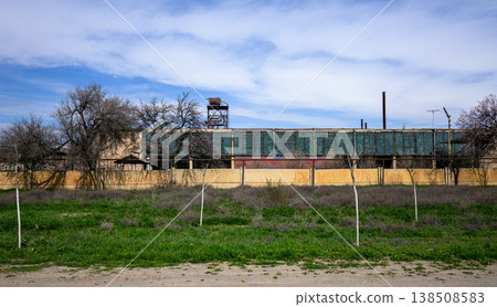 Abandoned factory structure under cloudy sky 138508583