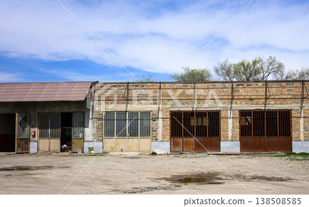 Abandoned industrial structure under clear sky with dry terrain Abandoned industrial structure under clear sky with dry terrain 138508585