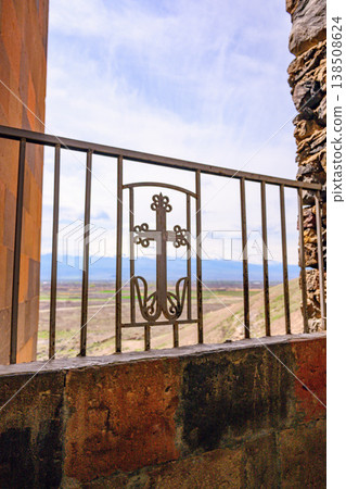 Rustic stone and metal barrier frames distant mountain range Rustic stone and metal barrier frames distant mountain range 138508624