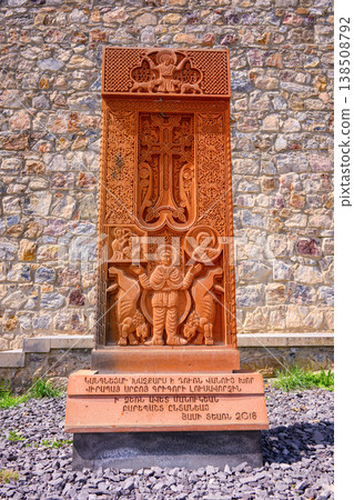 Rust-colored stone monument with intricate carvings 138508792