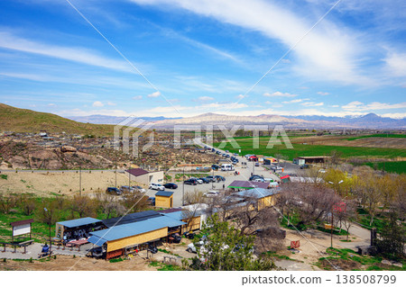 Scenic aerial view of rural settlement with scattered houses, vehicles Scenic aerial view of rural settlement with scattered houses, vehicles 138508799