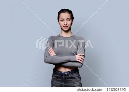 Portrait of beautiful young woman, 18-19 years old on gray background 138508895