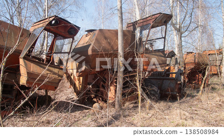 Abandoned combine harvesters in a thirty-kilometer radiation zone in Belarus. The resettlement zone after the Chernobyl nuclear power plant accident Abandoned combine harvesters in a thirty-kilometer radiation zone in Belarus. The resettlement zone after the Chernobyl nuclear power plant accident 138508984