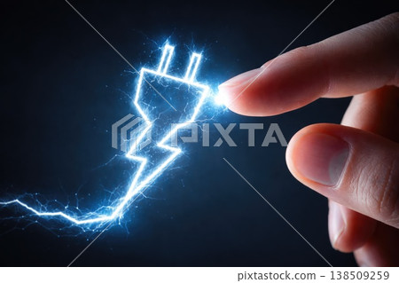 Glowing electric plug symbol touched by human finger representing energy and technology connection 138509259