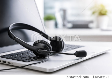 Customer support headset on laptop representing online service and communication Customer support headset on laptop representing online service and communication 138509322