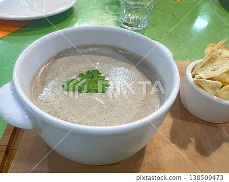 Cream of mushroom soup with croutons on a board Cream of mushroom soup with croutons on a board 138509473