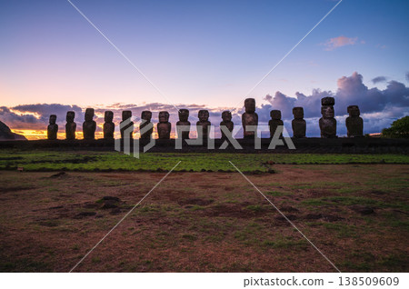 Majestic ancient moai statue standing proudly on easter island during serene sunrise over grassy rapa nui landscape evoking deep awe and mysterious historical wonder 138509609
