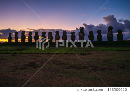 Majestic moai monuments stand silhouetted against dark sunset sky on rapa nui. ancient easter island landscape evokes peaceful mysterious emotion during evening dusk Majestic moai monuments stand silhouetted against dark sunset sky on rapa nui. ancient easter island landscape evokes peaceful mysterious emotion during evening dusk 138509610