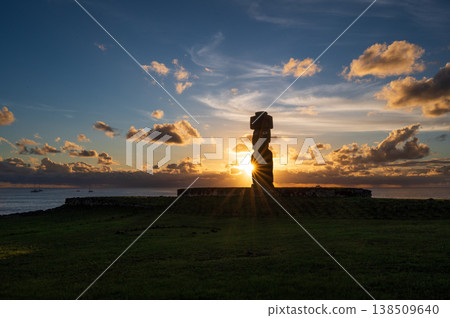 Majestic moai silhouette standing on easter island rapa nui glowing against scenic sunset sky over calm ocean radiating deep peaceful solitude and mysterious ancient wonder in nature Majestic moai silhouette standing on easter island rapa nui glowing against scenic sunset sky over calm ocean radiating deep peaceful solitude and mysterious ancient wonder in nature 138509640