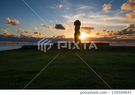 Majestic silhouette of mysterious moai statue on easter island rapa nui during peaceful sunset over ocean with radiant sunburst shining behind ancient stone monument Majestic silhouette of mysterious moai statue on easter island rapa nui during peaceful sunset over ocean with radiant sunburst shining behind ancient stone monument 138509641