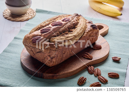 Homemade Banana Bread Loaf with Pecans on Board Homemade Banana Bread Loaf with Pecans on Board 138509765