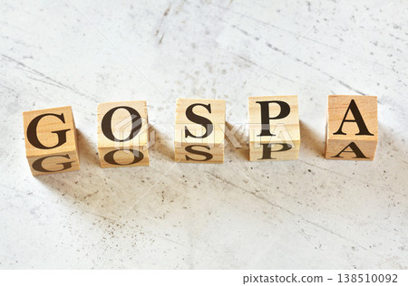 Five wooden cubes with letters GOSPA (stands for Goals Objectives Strategies Plans Activities) on white stone like board, view from above 138510092