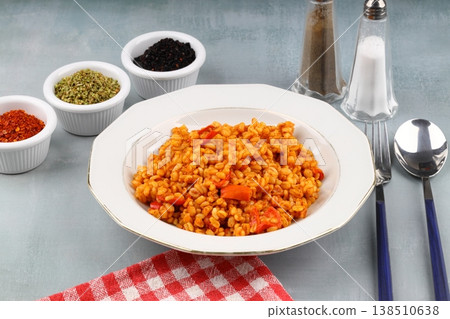 Traditional turkish bulgur pilaf with tomato sause in plate (Turkish name; meyhane pilavi) Traditional turkish bulgur pilaf with tomato sause in plate (Turkish name; meyhane pilavi) 138510638