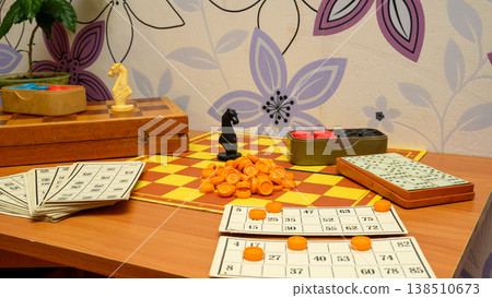 close up of lotto cards and chess pieces on the game board on a table in the room close up of lotto cards and chess pieces on the game board on a table in the room 138510673