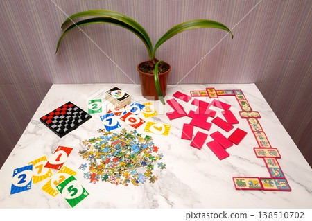 collection of board games and educational cards on a marble surface under a house flower collection of board games and educational cards on a marble surface under a house flower 138510702