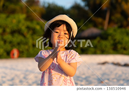 Japanese toddlers playing on the beach of a hotel in the Maldives at sunrise. 138510946