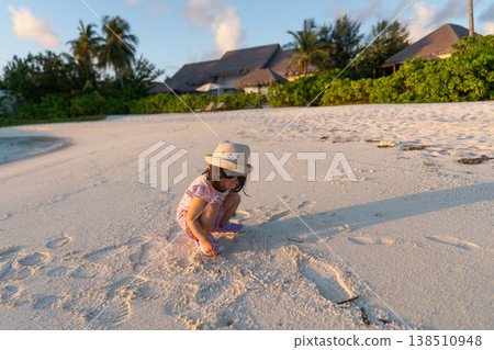 Japanese toddlers playing on the beach of a hotel in the Maldives at sunrise. 138510948