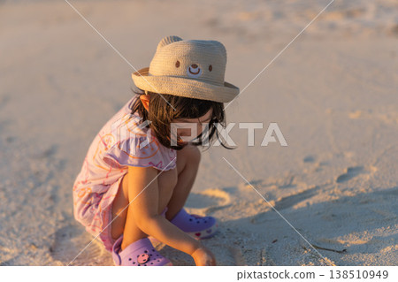 Japanese toddlers playing on the beach of a hotel in the Maldives at sunrise. Japanese toddlers playing on the beach of a hotel in the Maldives at sunrise. 138510949