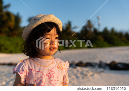 Japanese toddlers playing on the beach of a hotel in the Maldives at sunrise. Japanese toddlers playing on the beach of a hotel in the Maldives at sunrise. 138510950