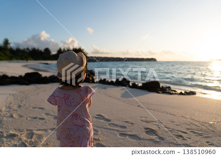 Japanese toddlers playing on the beach of a hotel in the Maldives at sunrise. 138510960
