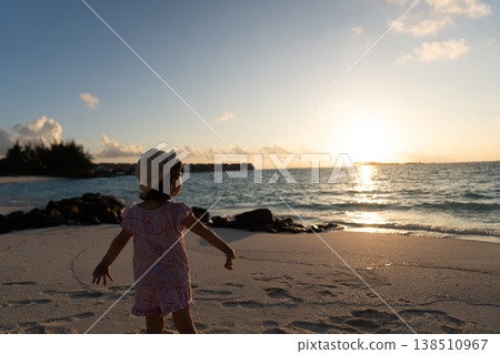 Japanese toddlers playing on the beach of a hotel in the Maldives at sunrise. Japanese toddlers playing on the beach of a hotel in the Maldives at sunrise. 138510967