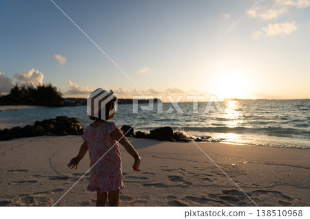 Japanese toddlers playing on the beach of a hotel in the Maldives at sunrise. Japanese toddlers playing on the beach of a hotel in the Maldives at sunrise. 138510968