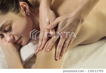 Female client getting shoulder massage at spa, relaxing wellness body care therapy Female client getting shoulder massage at spa, relaxing wellness body care therapy 138511703