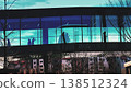 Unrecognizable Silhouettes In Glass Shopping Mall Passage Above Residential Area 138512324