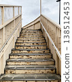 Going up the stairs of the pedestrian overpass 138512453