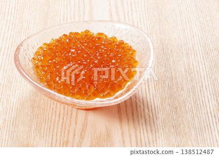 Salmon roe marinated in soy sauce, piled high on a glass plate and garnished with shiso leaves. Made with high-quality seafood ingredients, including salmon roe from autumn salmon caught in Hokkaido. 138512487
