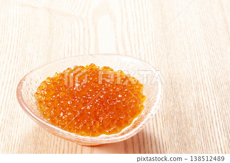 Salmon roe marinated in soy sauce, piled high on a glass plate and garnished with shiso leaves. Made with high-quality seafood ingredients, including salmon roe from autumn salmon caught in Hokkaido. 138512489