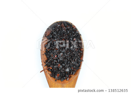 Macro Shot of Dried Isot Pepper Flakes in a Wooden Spoon Isolated on White Background - Turkish Chili 138512635