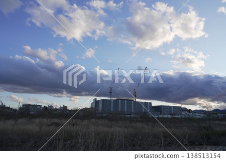 A crane at a construction site and the new building under construction: Taganomori Elementary and Junior High School 138513154