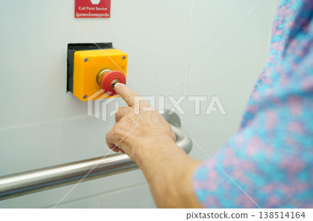 Asian elderly woman press emergency button in toilet. Asian elderly woman press emergency button in toilet. 138514164