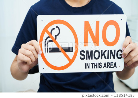 Male holding a no smoking sign. 138514183