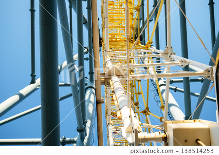 Symmetric upward view of mechanical steel tubes and yellow inner truss structure of Mtatsminda Park wheel Symmetric upward view of mechanical steel tubes and yellow inner truss structure of Mtatsminda Park wheel 138514253