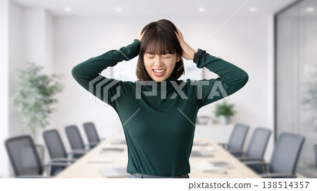A woman/businesswoman holding her head in trouble A woman/businesswoman holding her head in trouble 138514357