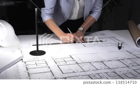 Architect developing blueprint for construction project, drafting building plan using ruler on desk with safety hard hat. Business and architect people concept Architect developing blueprint for construction project, drafting building plan using ruler on desk with safety hard hat. Business and architect people concept 138514710